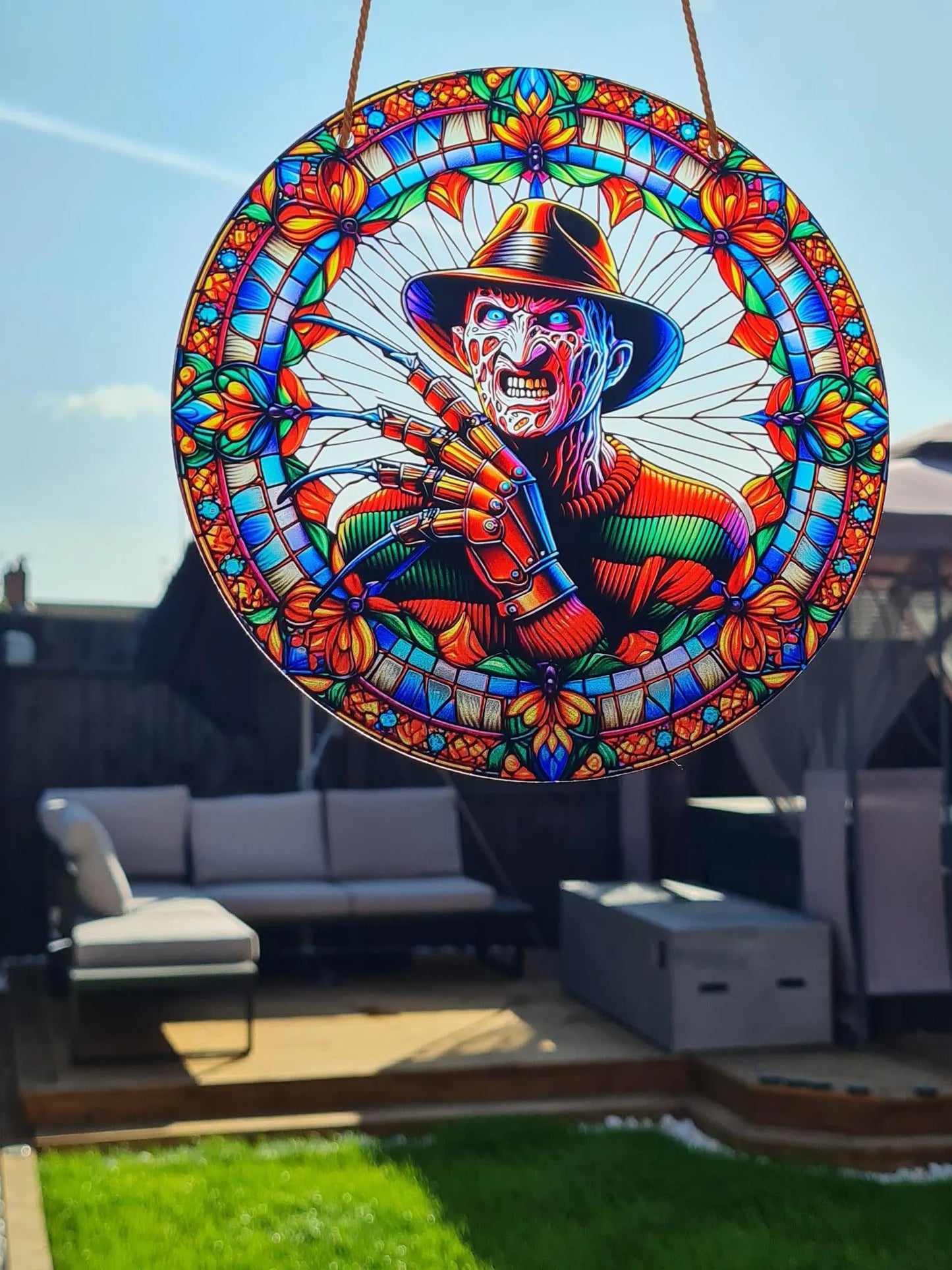 Gothic stained glass sun catcher featuring an scary Freddy Krueger from the nightmare nightmare on elm street. Perfect for adding a spooky yet charming touch to any window or garden decor.