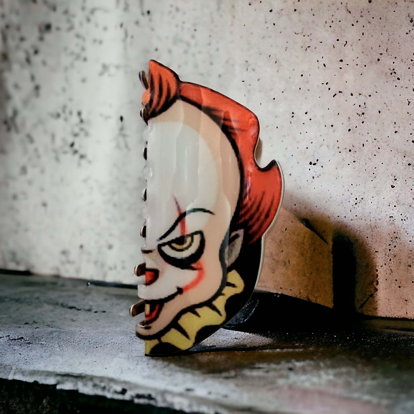 Pennywise horror collectible hair clip for horror fans.