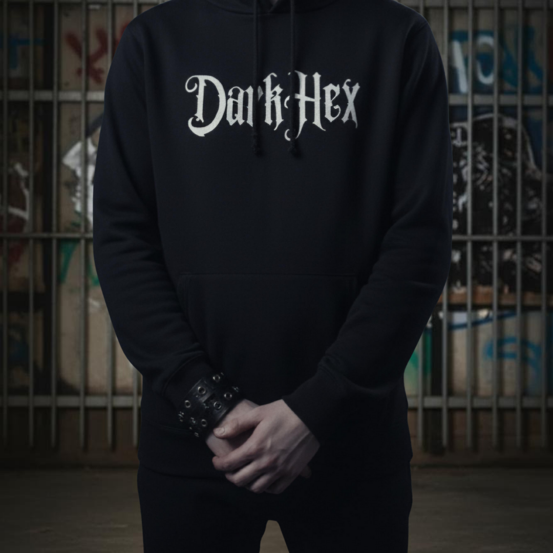 Person wearing a black hoodie with 'Dark Hex' text in front of a graffiti-covered wall.