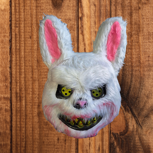 A white faux fur evil bunny mask with a blood-stained snout, yellow fangs, and floppy ears, secured with an elastic band, ideal for Halloween or cosplay