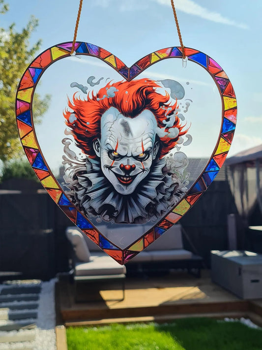 Gothic stained glass sun catcher featuring an pennywise from the IT films . Perfect for adding a spooky yet charming touch to any window or garden decor.