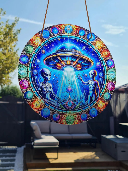 Gothic stained glass sun catcher featuring an adorable aliens and ship within a crescent moon adorned with bat wings and vibrant autumnal leaves. Perfect for adding a spooky yet charming touch to any window or garden decor.