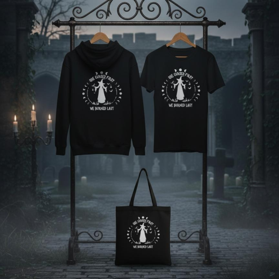 Black hoodie, tote bag, and t-shirt with a printed design on a dark background